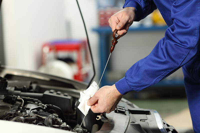 Service Technician Checking Oil at Master Buick GMC in Augusta GA